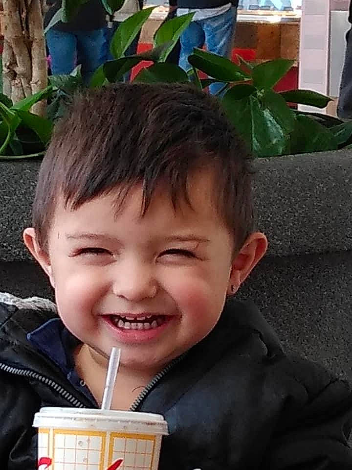 Josiah is registered to the contest to win money with this photo: child, drink, drinking, event, fun, gesture, green, happy, joy, junk_food, laugh, leisure, person, photograph, photography, plant, selfie, sitting, smile, snapshot