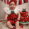 baby, birthday, black, cake, carpet, celebration, costume, cute, decorations, dots, happy, headband, infant, ladybug, portrait, red, shoes, sitting, smiling, white