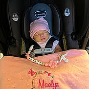 Maelys is registered to the contest to win money with this photo: adorable, baby, blanket, car_seat, child, cute, embroidery, indoors, infant, newborn, pacifier, pacifier_clip, peaceful, personalized, pink_hat, resting, safety, seatbelt, sleeping, soft_lighting