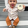 baby, child, smiling, cap, shirt, pants, shoes, milestone, sign, steps, porch, outdoor, happy, cute, person, sitting, clothing, footwear, face, portrait