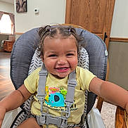Wrenleigh joined the competition — help win amazing prizes! toddler, child, high_chair, smiling, happy, baby, indoors, wood, hair, pigtails, clothing, seatbelt, furniture, face, person, room, window, curtain, table, shirt