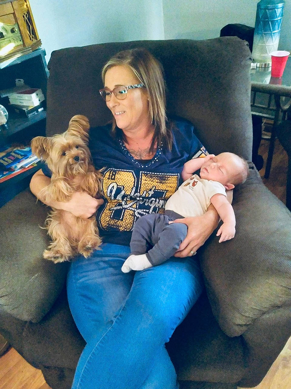 Winston joined the competition — help win amazing prizes! baby, blue, carnivore, child, comfort, companion_dog, couch, dog, dog_breed, eyewear, fun, hairstyle, happy, interaction, lap, living_room, sitting, smile, thigh, toy_dog