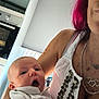 Nëylia participe au concours pour gagner de l'argent avec cette photo : baby, adult, face, person, arm, clothing, jewelry, kitchen, bracelet, pink_hair, expression, indoor, holding, white_shirt, appliance, necklace, skin, furniture, background, portrait