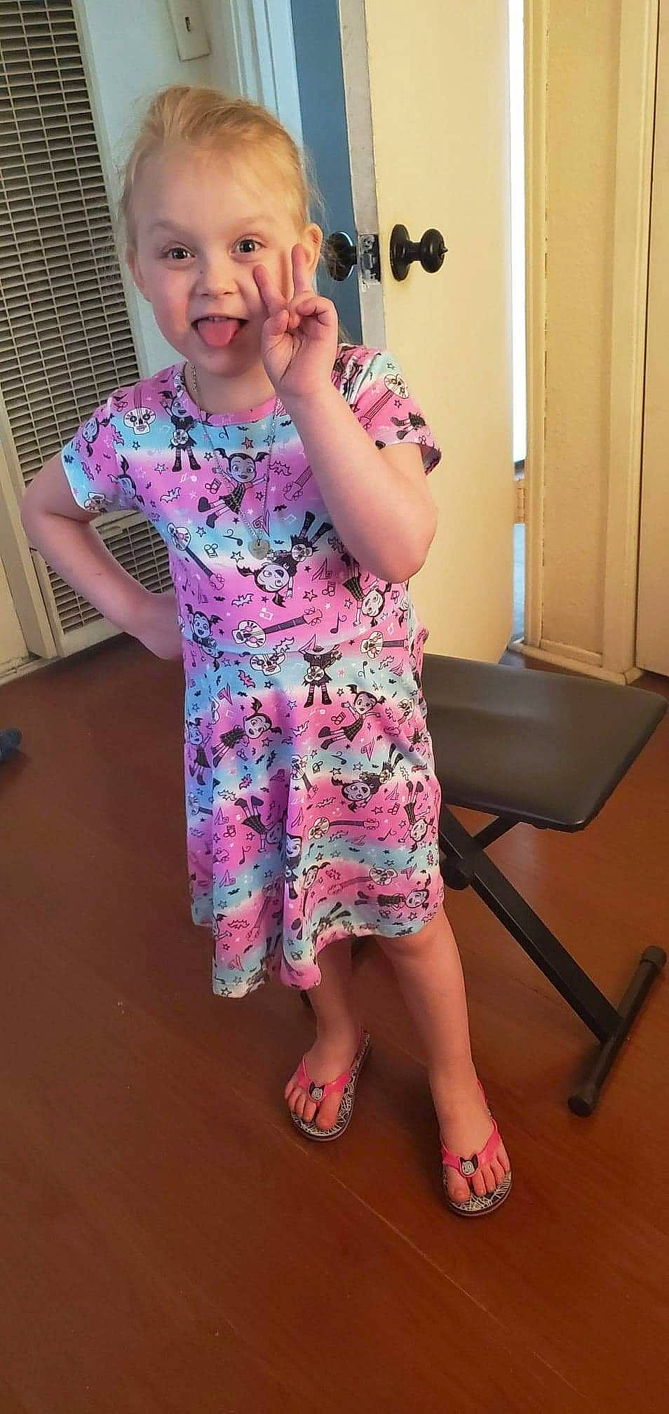 Kodie is registered to the contest to win money with this photo: arm, baby, child, dress, leg, person, pink, play, shoulder, sitting, skin, sleeve, toddler