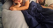 Kaidence is registered to the contest to win money with this photo: child, man, sleeping, bed, blanket, pillow, indoor, rest, hair_clips, curly_hair, beard, casual_clothing, relaxation, cozy, family, nap, comfort, tired, peaceful, portrait