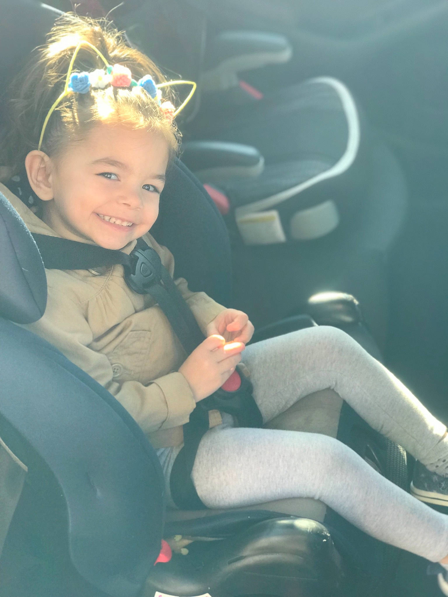 Lola is registered to the contest to win money with this photo: baby, blond, child, family_car, hair_accessory, headgear, headpiece, joy, person, personal_protective_equipment, photography, recreation, smile, toddler, vacation, wetsuit