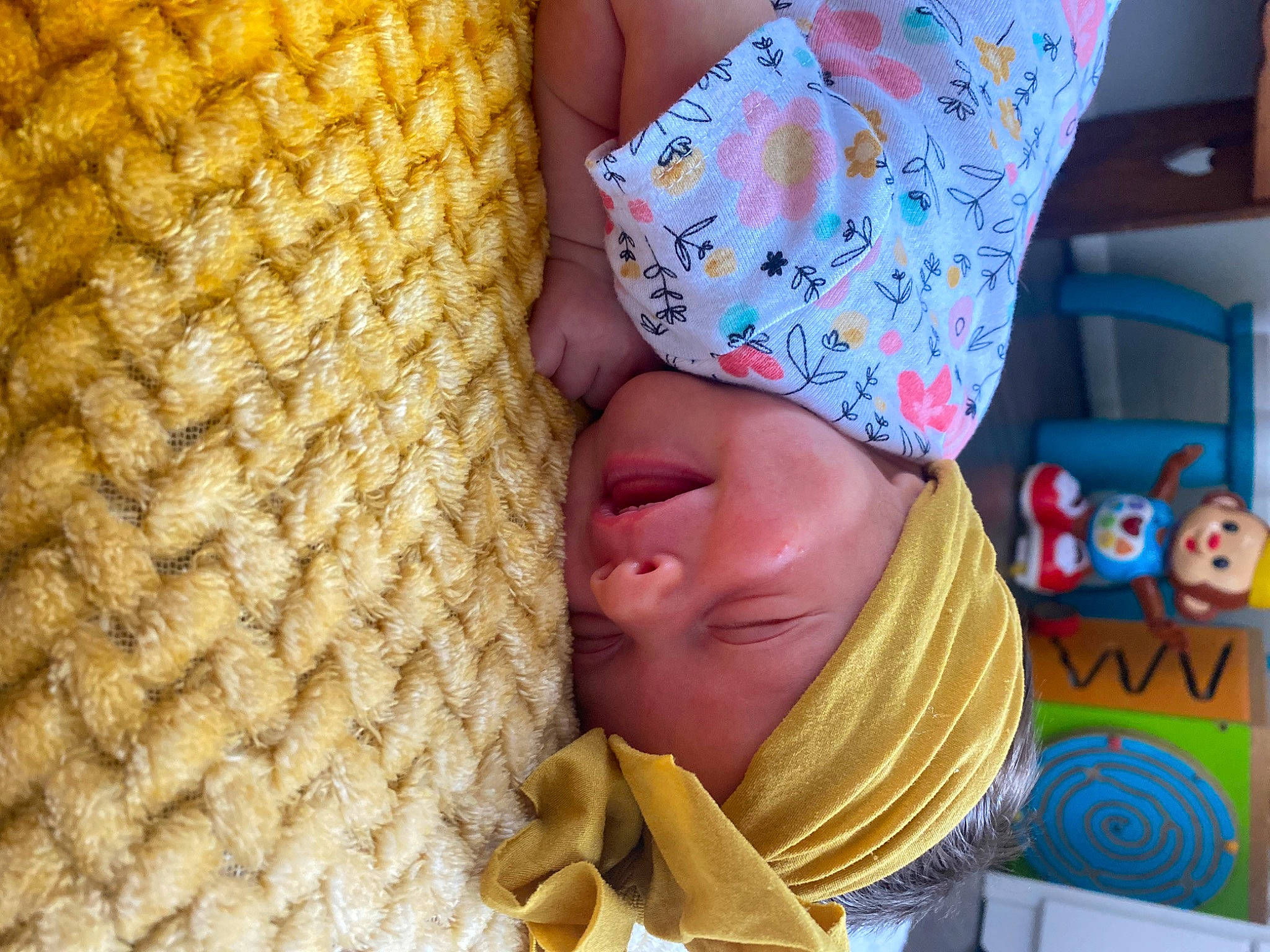 Isla is registered to the contest to win money with this photo: baby, baby_products, child, comfort, couch, fashion_accessory, fun, happy, headgear, headwear, leisure, linens, pattern, people_in_nature, person, room, scarf, smile, textile, toddler