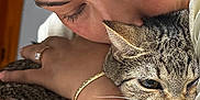 Milu joined the competition — help win amazing prizes! person, cat, tabby_cat, hugging, affection, close_up, face, hand, jewelry, earrings, bracelet, nail_polish, indoor, skin, fur, whiskers, expression, love, cute, pet