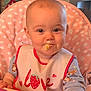 baby, bib, child, clothing, cute, expression, face, feeding, food, high_chair, indoor, infant, love, person, pink, polka_dot, sitting, smile, strawberry, table