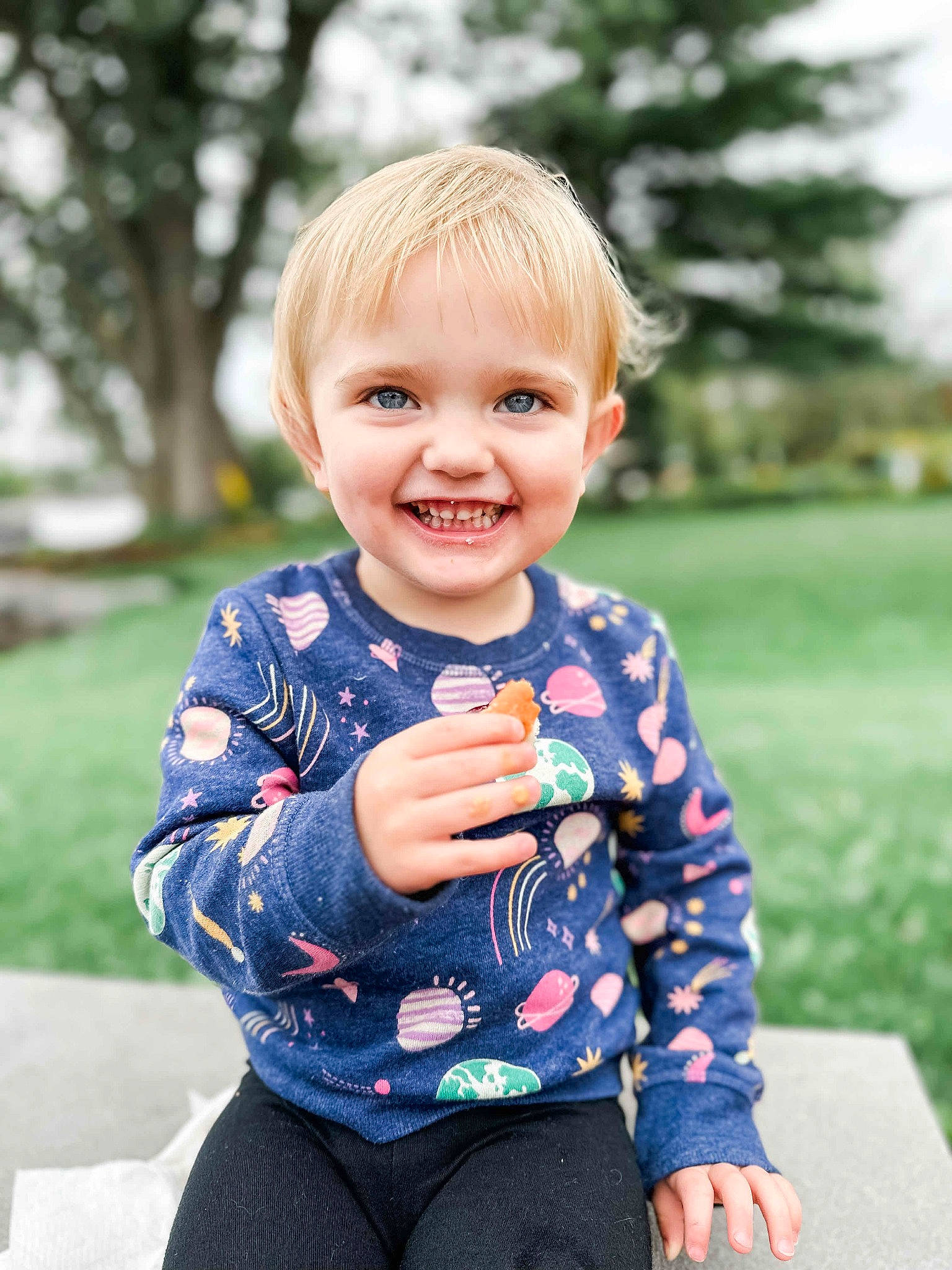 Delilah is registered to the contest to win money with this photo: baby, baby_toddler_clothing, child, electric_blue, eye, face, gesture, grass, happy, joint, joy, leisure, people_in_nature, person, plant, shoulder, skin, sleeve, smile, standing