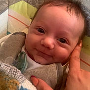 Maël a rejoint le concours — aidez-le/la à gagner de superbes lots ! baby, infant, smile, face, hand, blanket, knitwear, pacifier, bed, cushion, comfort, soft, cute, human, portrait, closeup, child, warm, rest, cozy