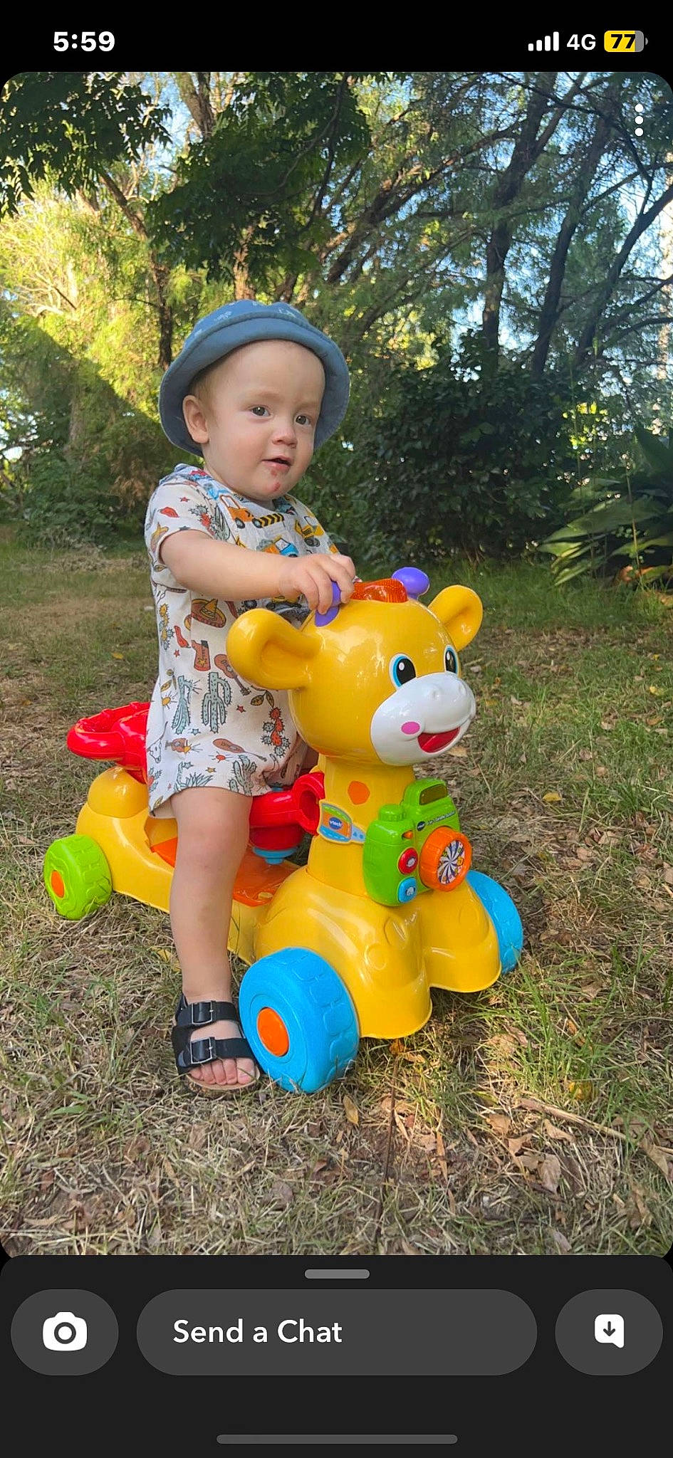 Isaiah joined the competition — help win amazing prizes! baby, baby_toddler_clothing, child, city, fun, garden, grass, happy, hat, headwear, leisure, magenta, people_in_nature, person, plant, play, recreation, sitting, teddy_bear, toddler