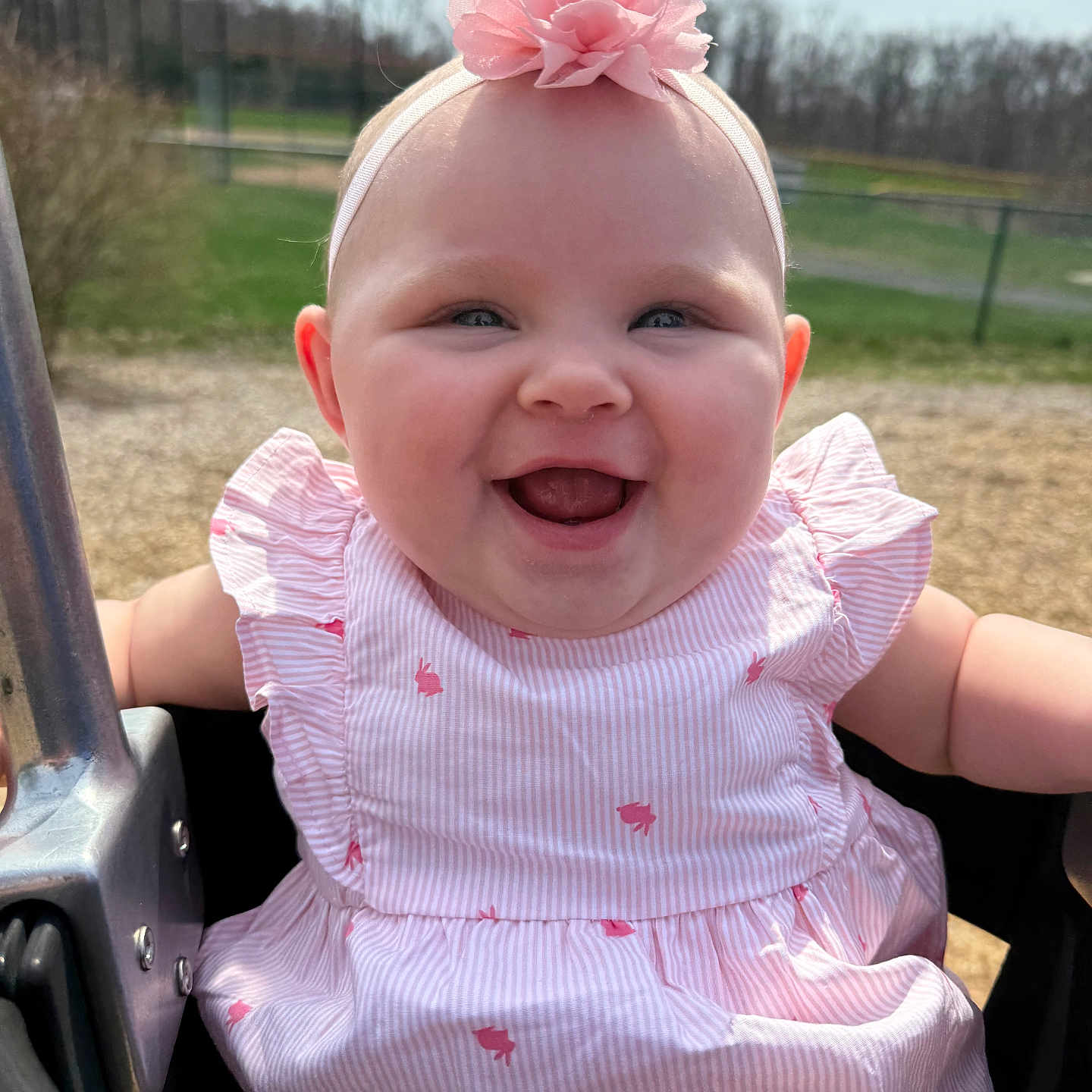 Charlotte is registered to the contest to win money with this photo: baby, child, cute, flower, fun, girl, happy, headband, infant, joy, nature, outdoor, park, pink_dress, playground, portrait, smiling, summer, sunlight, swing
