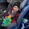 Shay joined the competition — help win amazing prizes! toddler, child, car_seat, toy_airplane, jacket, beanie, car_interior, seatbelt, smile, happy, window, cage, diaper, bag, green_toy, clothing, person, safety, travel, infant