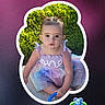baby, background, button, child, colorful, cute, dress, face, frame, grass, greenery, outdoor, person, pigtails, portrait, sitting, social_media, text_overlay, toddler, toy