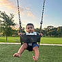 toddler, child, swing, park, grass, trees, sunset, outdoor, playground, legs, barefoot, curly_hair, baby, seat, metal_chains, nature, sky, bench, sidewalk, summer