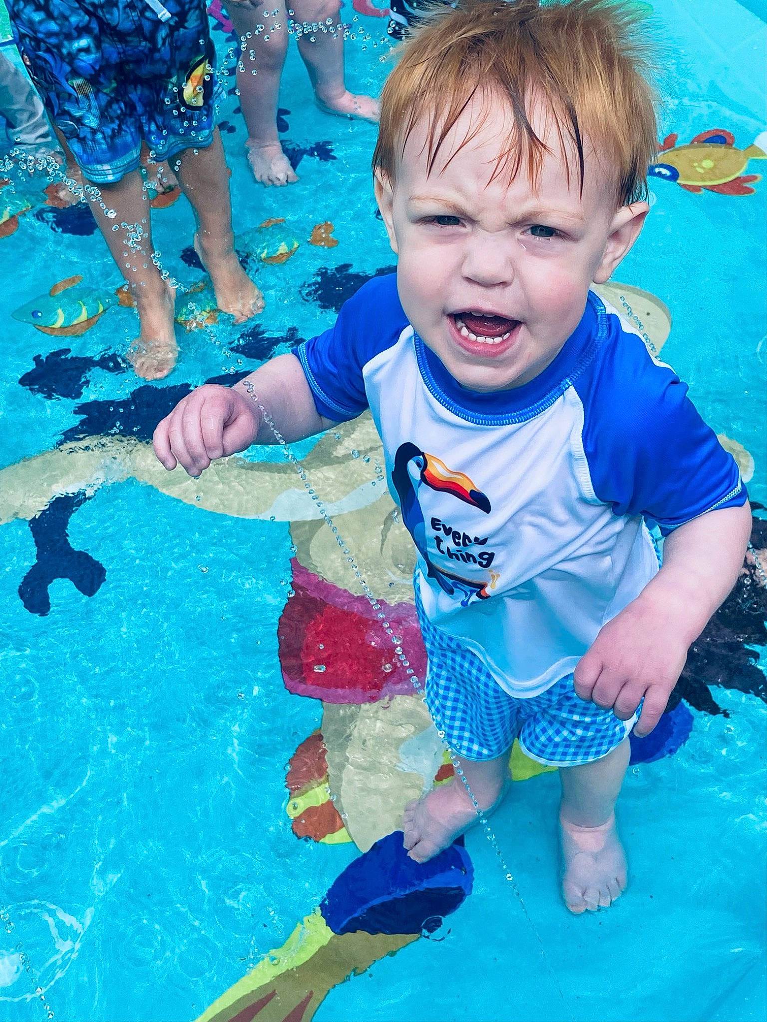 Beckett is registered to the contest to win money with this photo: aqua, azure, baby, baby_toddler_clothing, blue, child, electric_blue, fun, green, happy, leisure, people, person, recreation, red, shorts, sorrow, swimming_pool, toddler, water