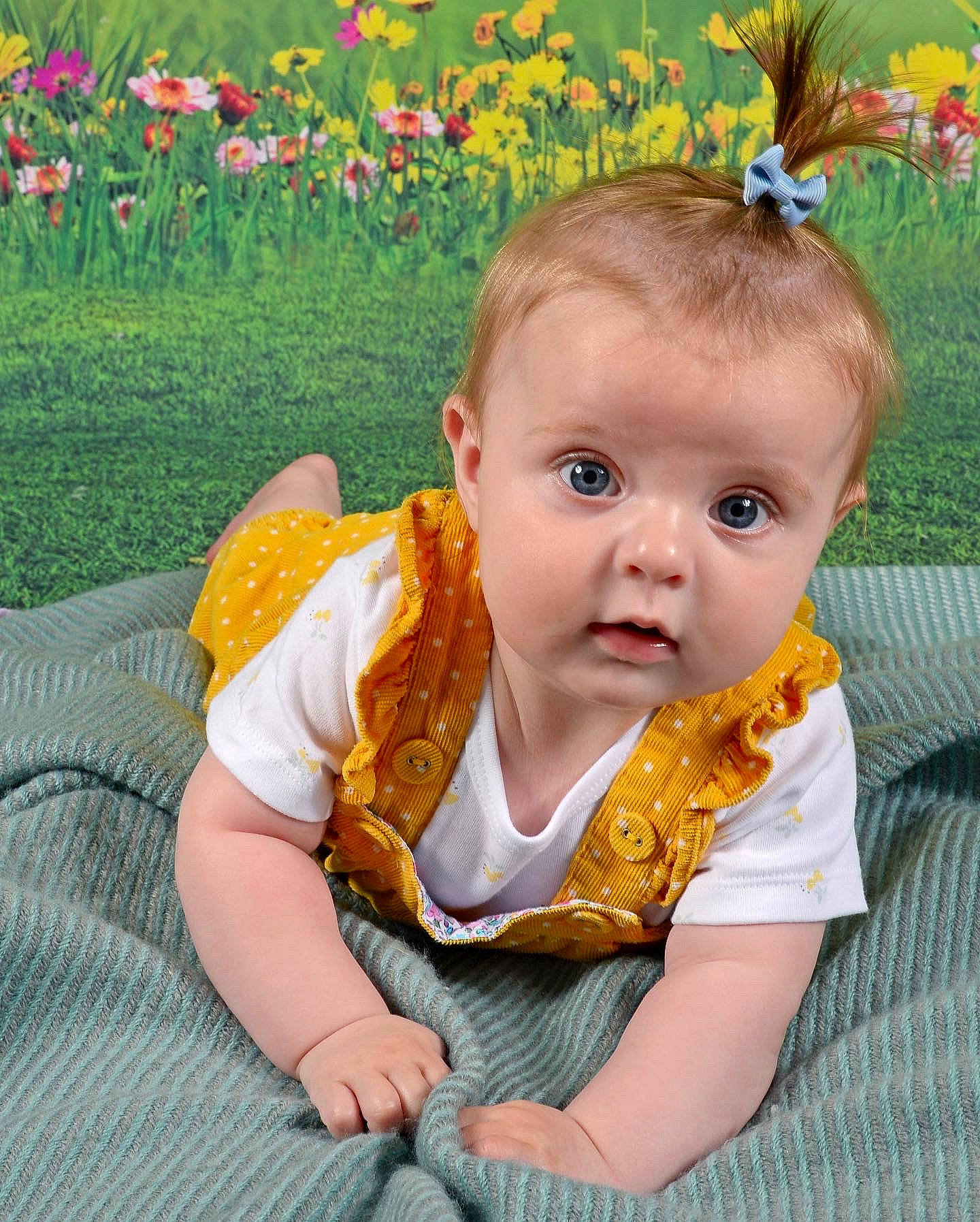 Emelia is registered to the contest to win money with this photo: baby_toddler_clothing, botany, cheek, chin, eye, face, facial_expression, flower, green, hair, hairstyle, happy, head, human_body, iris, leaf, person, plant, product, skin