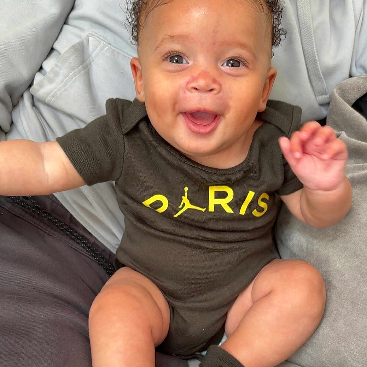 Khalesei joined the competition — help win amazing prizes! adult, baby, casual_clothing, child, couch, curly_hair, cute, face, hand, happy, indoor, infant, legs, logo, onesie, person, seated, skin, smiling, socks