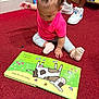toddler, child, book, reading, carpet, pink_bow, curly_hair, socks, sitting, cartoon, cow, illustration, red_carpet, footwear, sneakers, adult, legs, indoor, store, bookshelf