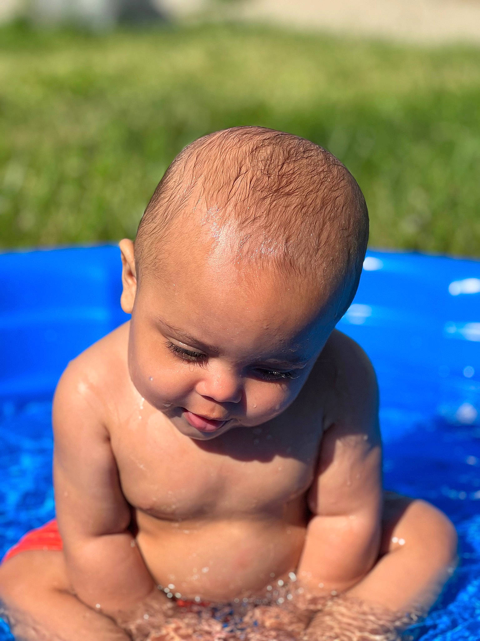 Josiah joined the competition — help win amazing prizes! abdomen, baby, baby_bathing, barechested, bathing, blue, chest, child, face, fun, grass, happy, leisure, muscle, person, recreation, sitting, skin, swimming_pool, toddler