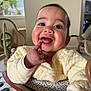 Daniela joined the competition — help win amazing prizes! baby, child, smile, happy, indoor, yellow_clothing, face, finger, teeth, toy, window, light, cute, infant, person, playful, expression, sitting, cozy, quilted