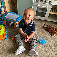 Ollie joined the competition — help win amazing prizes! ball, boy, child, clothing, face, footwear, furniture, happy, head, indoors, interiordesign, jeans, male, pants, person, photography, portrait, shoe, sitting, sneaker