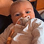 Athéna participe au concours pour gagner de l'argent avec cette photo : baby, pacifier, blanket, wooden_beads, clothing, face, infant, indoors, resting, comfort, child, soft_toys, bedroom, person, portrait, cute, young_child, baby_girl, baby_boy, warm