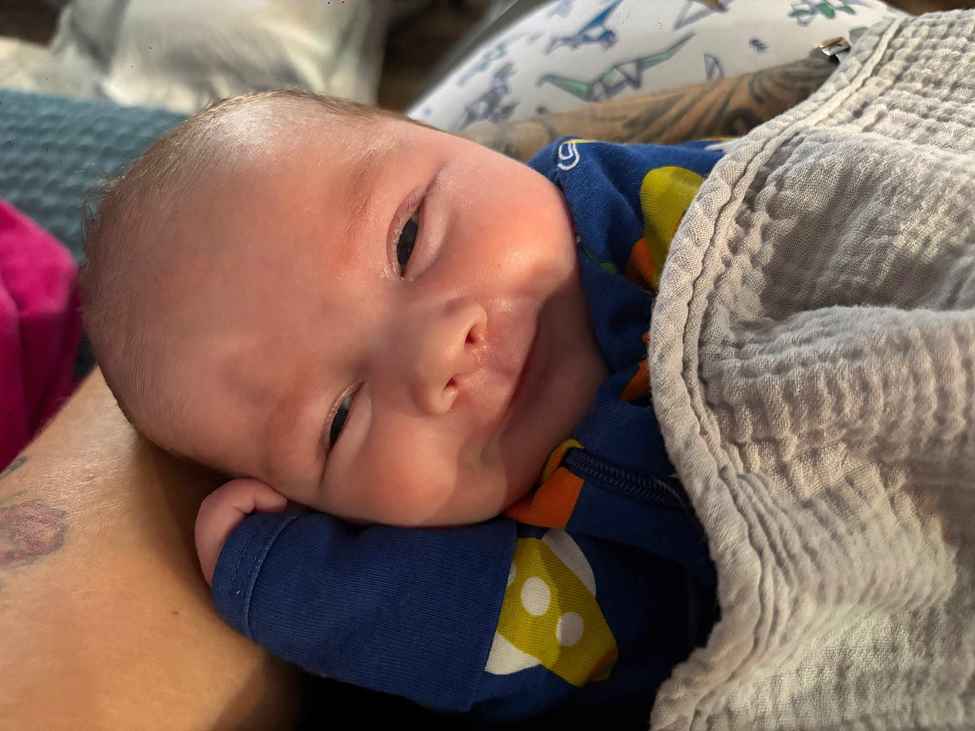 Jayden joined the competition — help win amazing prizes! baby, blanket, arm, clothing, comfort, face, hand, infant, person, portrait, resting, smile, sleepy, soft_texture, toddler, warm, young_child, cute, close_up, indoor