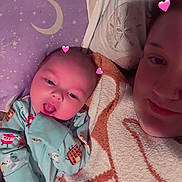 Jayden joined the competition — help win amazing prizes! baby, adult, bed, blanket, pillow, hearts, sleepwear, person, face, cozy, cute, lying_down, purple, pattern, smile, hand, mouth_open, indoor, child, family