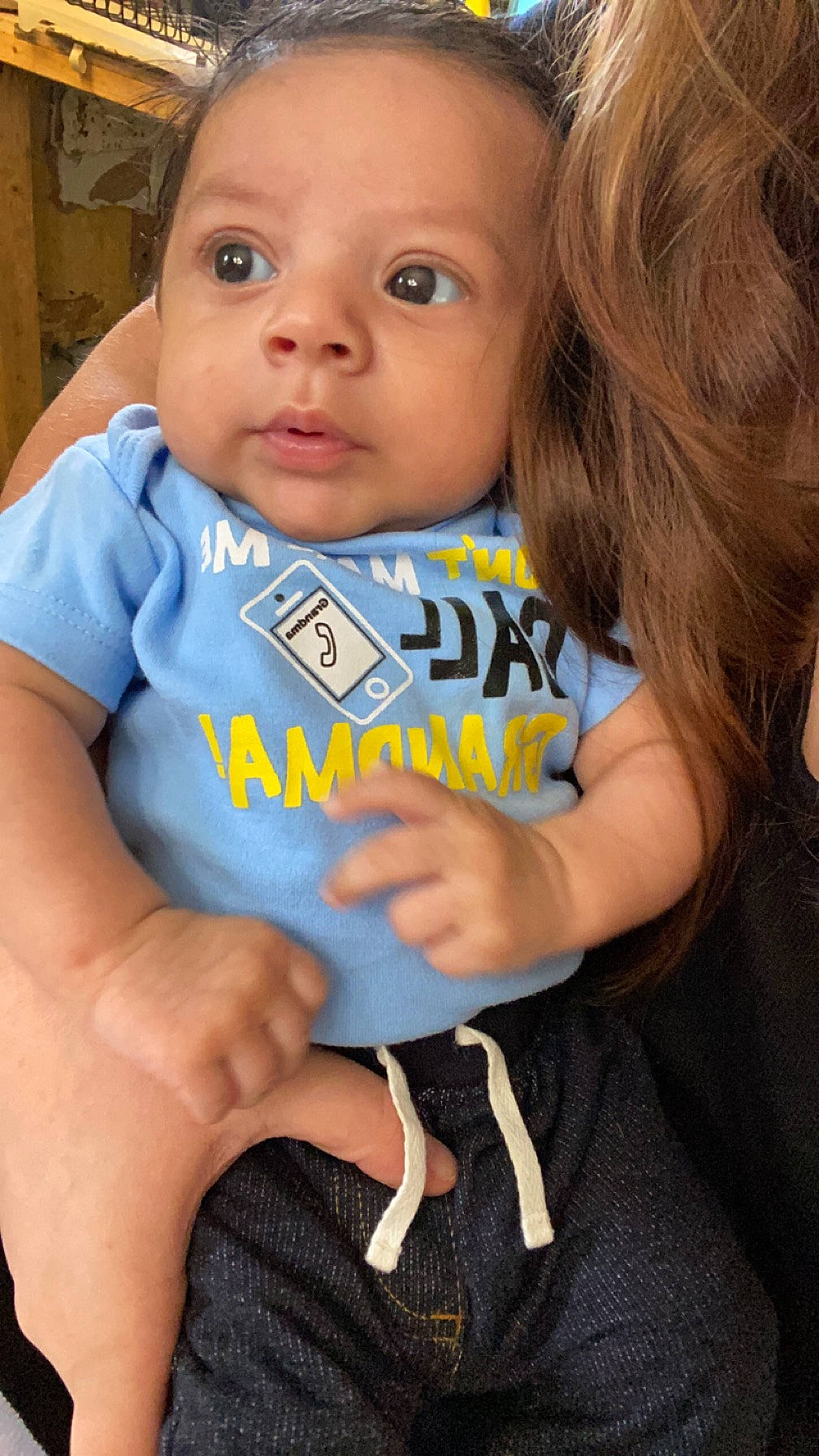 Sebastian is registered to the contest to win money with this photo: arm, baby_toddler_clothing, cheek, eye, eyelash, face, finger, gesture, hair, hairstyle, hand, happy, iris, joint, lip, nose, person, shoulder, skin, sleeve