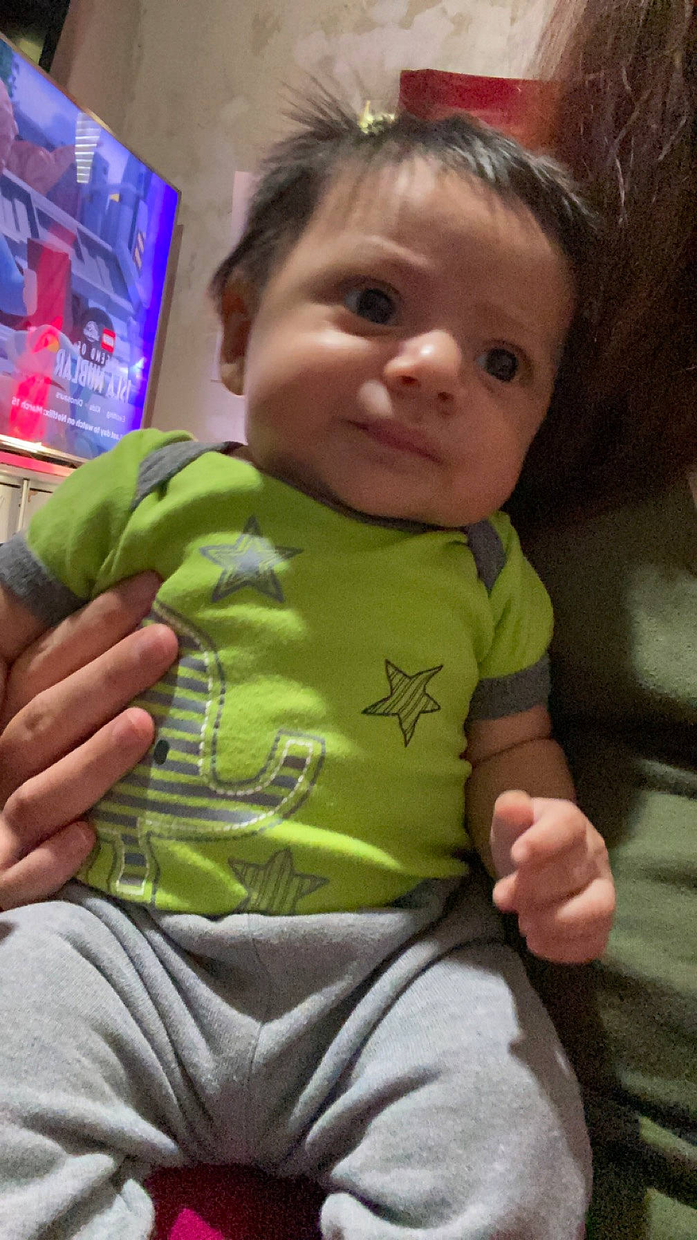 Sebastian is registered to the contest to win money with this photo: baby, baby_toddler_clothing, cheek, child, face, facial_expression, finger, gesture, hairstyle, happy, iris, lip, mouth, nose, person, skin, sleeve, standing, t_shirt, thumb