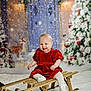baby, child, sled, red_dress, snow, christmas_tree, reindeer, holiday, winter, festive, smiling, indoor, decorations, white_tights, wood, cute, portrait, seasonal, happy, celebration