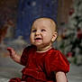 baby, child, red_dress, smiling, holiday, christmas, festive, indoor, portrait, cute, infant, decorations, soft_toys, happy, sitting, winter, celebration, closeup, face, holiday_season