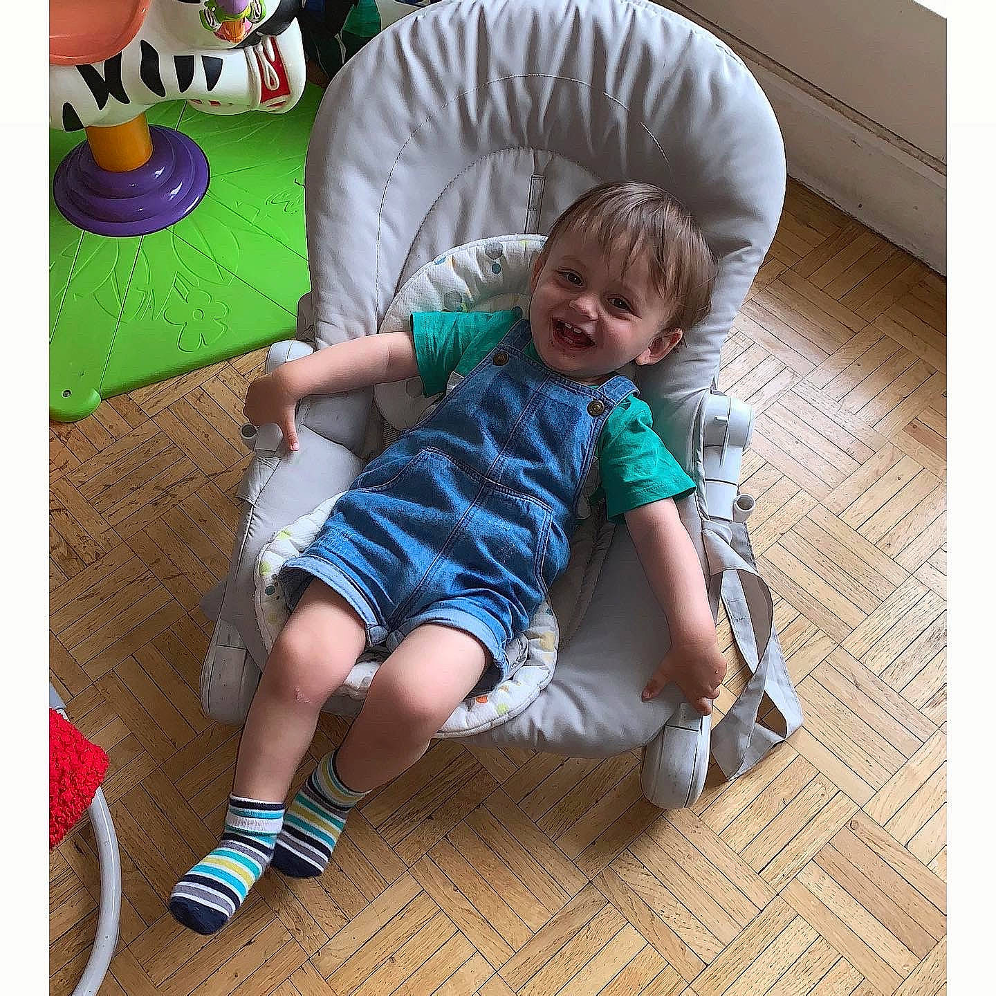 Adam a rejoint le concours — aidez-le/la à gagner de superbes lots ! baby, baby_toddler_clothing, child, comfort, couch, flooring, fun, hardwood, knee, lap, leg, leisure, person, product, shoe, sitting, smile, sneakers, sock, toddler