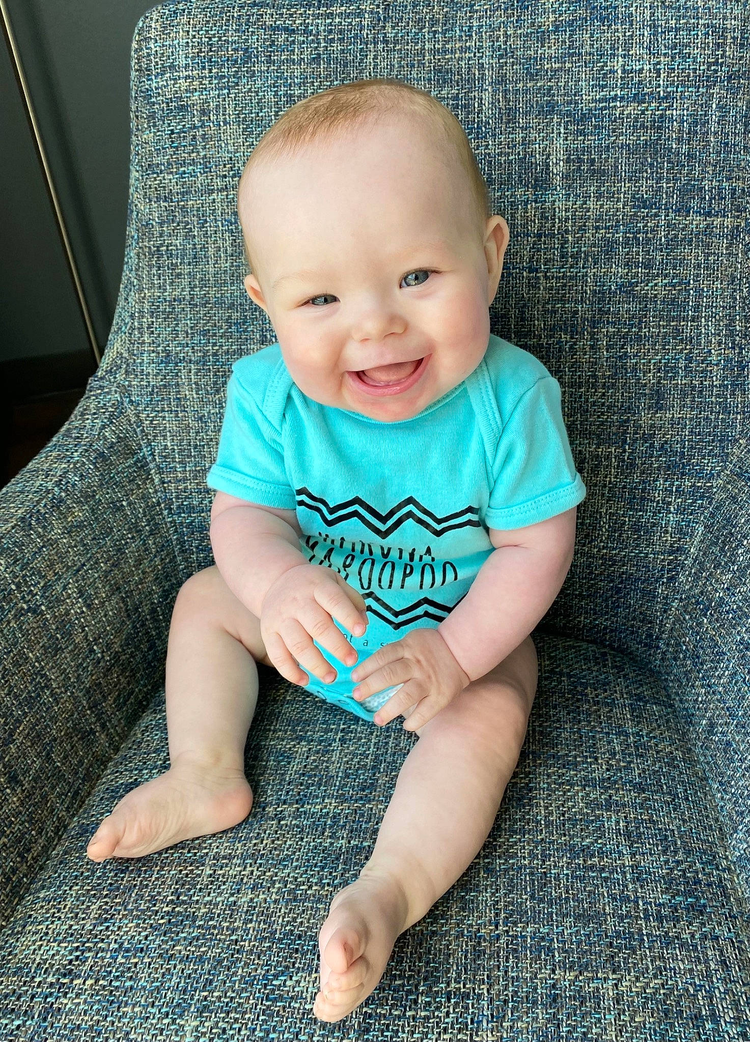 Daxtin is registered to the contest to win money with this photo: aqua, arm, azure, baby, baby_toddler_clothing, blue, cheek, comfort, eye, face, flash_photography, happy, head, iris, joy, leg, person, skin, sleeve, smile
