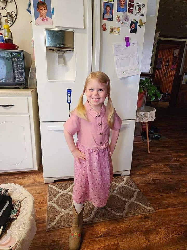 Haygan is registered to the contest to win money with this photo: baby_toddler_clothing, blurred, cabinetry, child, drawer, dress, floor, flooring, fun, happy, hardwood, home_appliance, homemaker, joy, kitchen_appliance, person, play, purple, refrigerator, room
