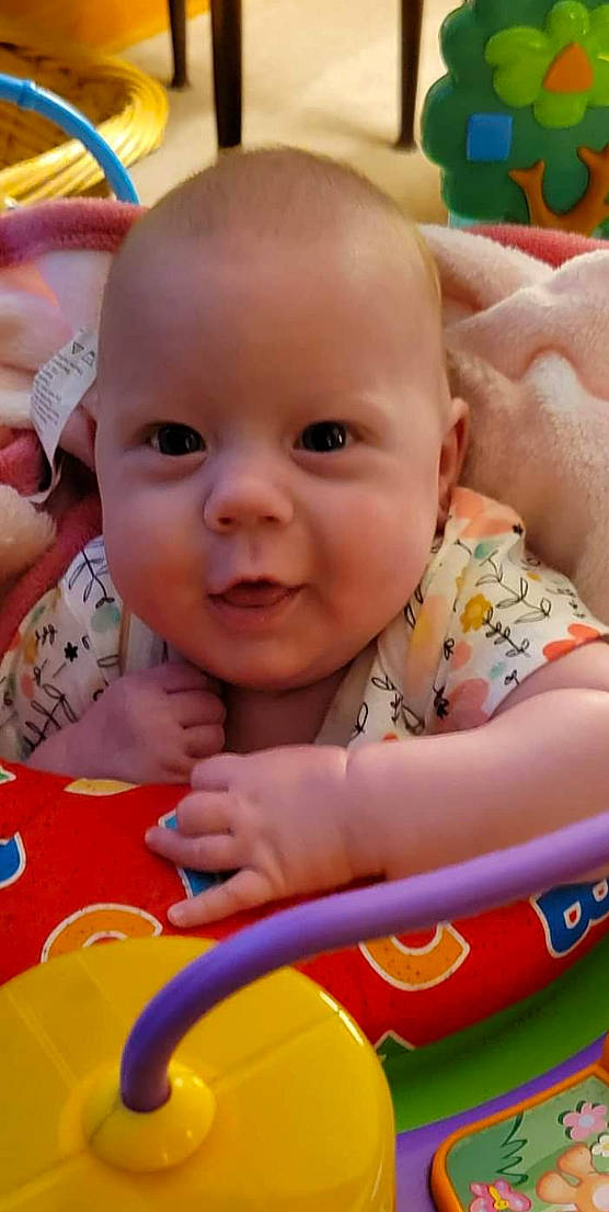 Henley joined the competition — help win amazing prizes! baby, baby_playing_with_toys, cheek, chin, facial_expression, finger, fun, happy, iris, mouth, nose, orange, person, photograph, pink, product, skin, smile, summer, toddler