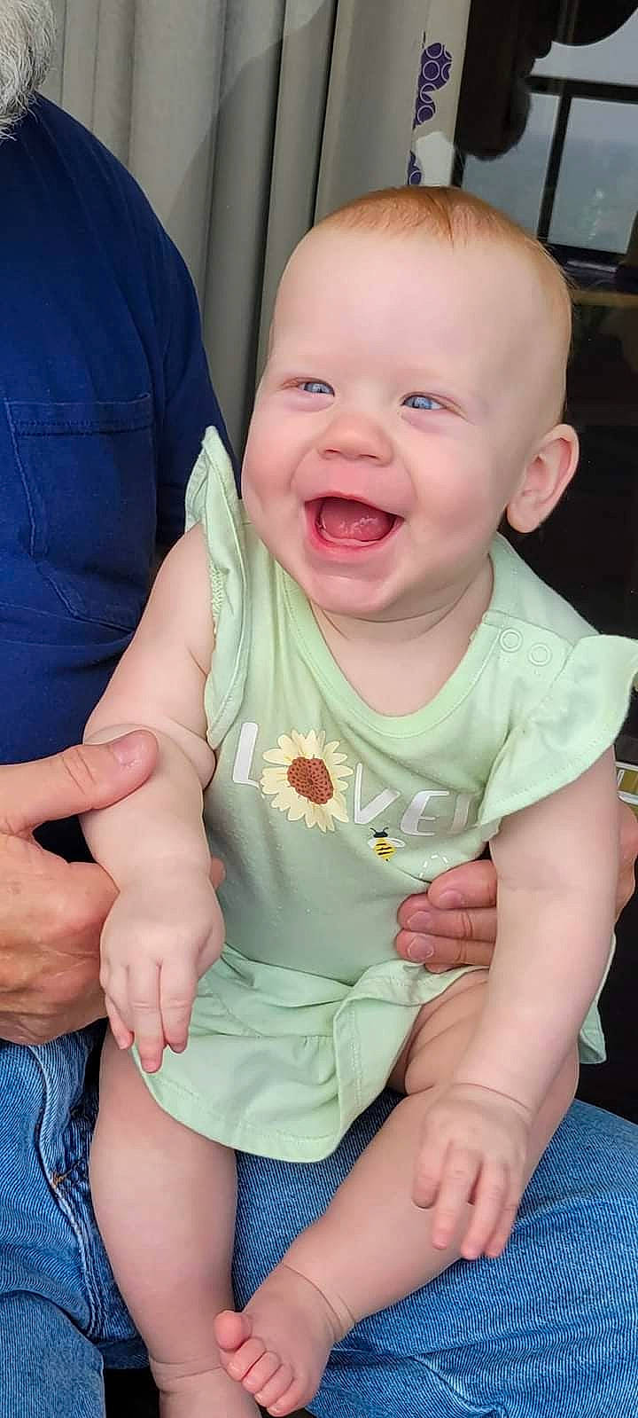 Henley is registered to the contest to win money with this photo: baby, baby_toddler_clothing, cheek, chest, child, comfort, face, finger, gesture, hand, happy, head, joy, lip, mouth, person, sitting, skin, sleeve, smile