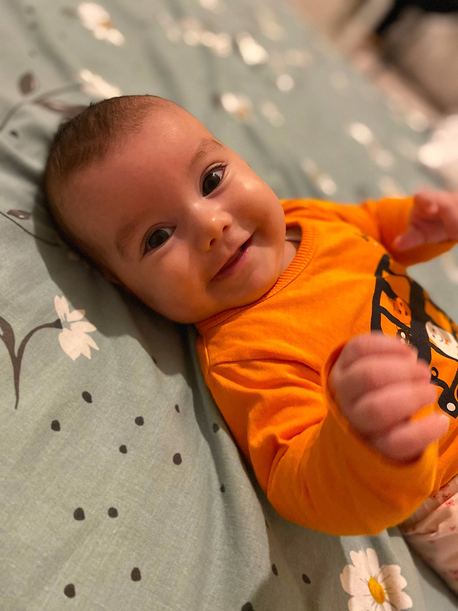 Mia is registered to the contest to win money with this photo: baby, baby_toddler_clothing, cheek, child, comfort, eye, facial_expression, fun, happy, iris, linens, nose, orange, people, person, skin, sleeve, smile, toddler, tree