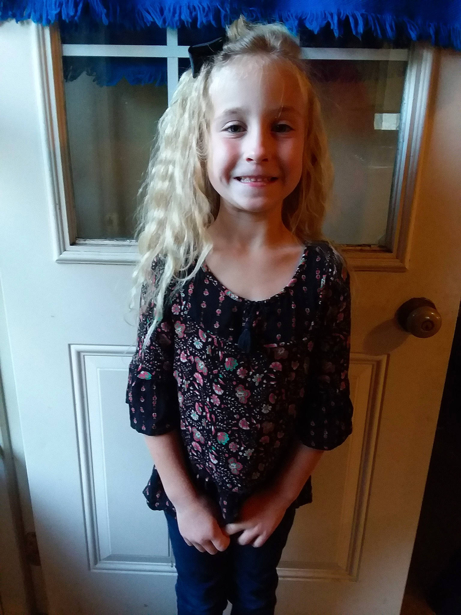 Nevaeh is registered to the contest to win money with this photo: blond, child, child_model, clothing, day, girl, hair, hairstyle, human_hair_color, joint, joy, long_hair, outerwear, person, shoulder, sleeve, smile, standing, sweater, textile