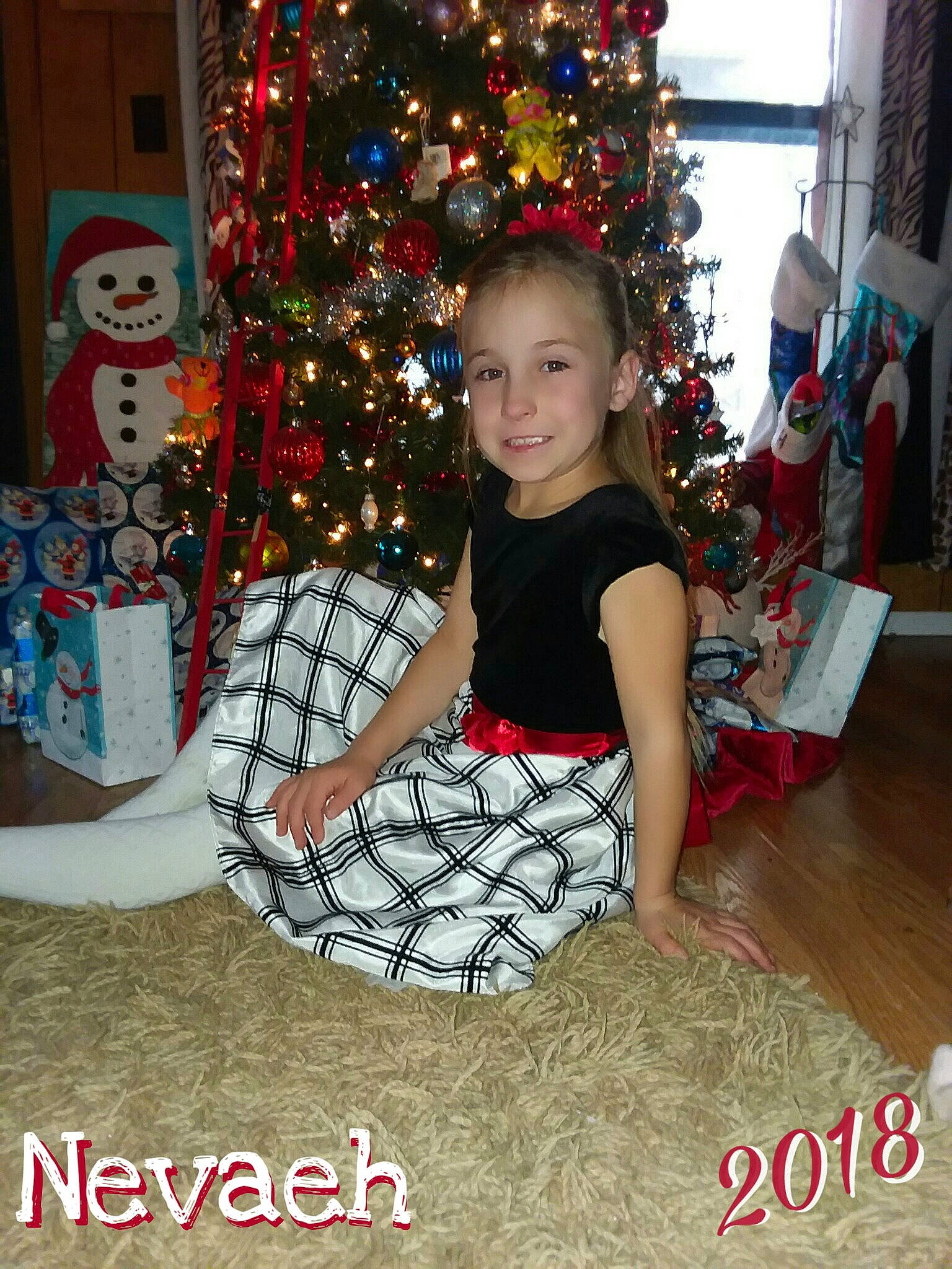 Nevaeh is registered to the contest to win money with this photo: child, christmas, christmas_decoration, christmas_tree, event, girl, holiday, joy, pattern, person, product, toddler