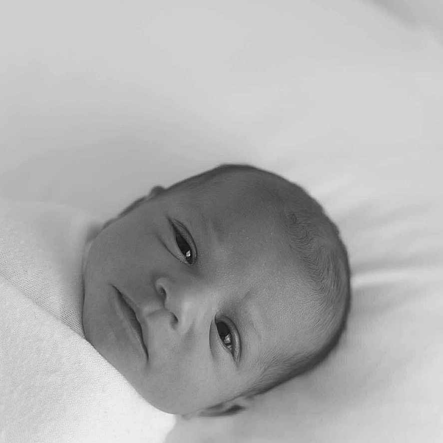 Azelia is registered to the contest to win money with this photo: baby, black_and_white, blanket, calm, close_up, cute, face, head, indoors, infant, lying_down, monochrome, newborn, newborn_baby, peaceful, person, portrait, sleeping_area, soft, swaddled