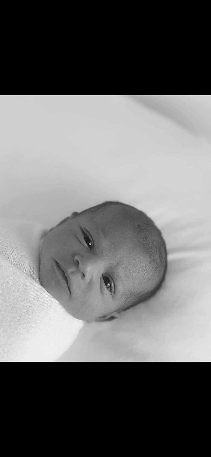 Azelia is registered to the contest to win money with this photo: baby, newborn, black_and_white, portrait, swaddled, blanket, infant, face, head, sleeping_area, soft, cute, lying_down, close_up, peaceful, newborn_baby, person, monochrome, indoors, calm
