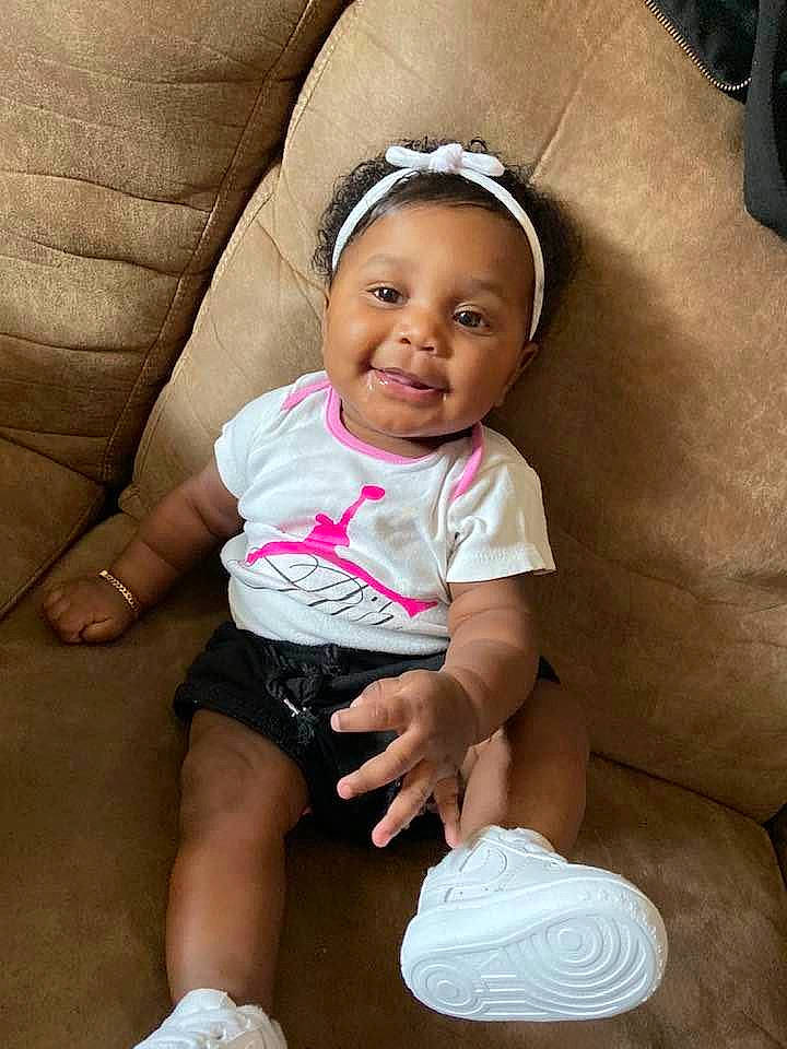 Samaya is registered to the contest to win money with this photo: baby, baby_products, baby_toddler_clothing, cheek, child, finger, hair_accessory, head, headband, headgear, joy, person, pink, product, skin, smile, toddler