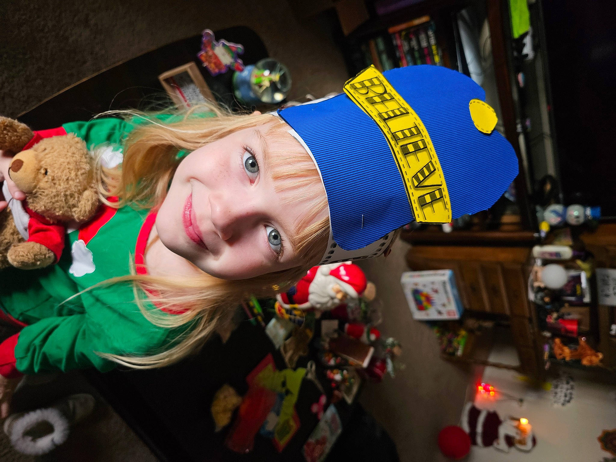 Brooklyn Skye Baze is registered to the contest to win money with this photo: child, christmas, christmas_eve, costume, event, fashion_accessory, fun, fur, happy, headwear, holiday, joy, person, plastic, room, smile, toy