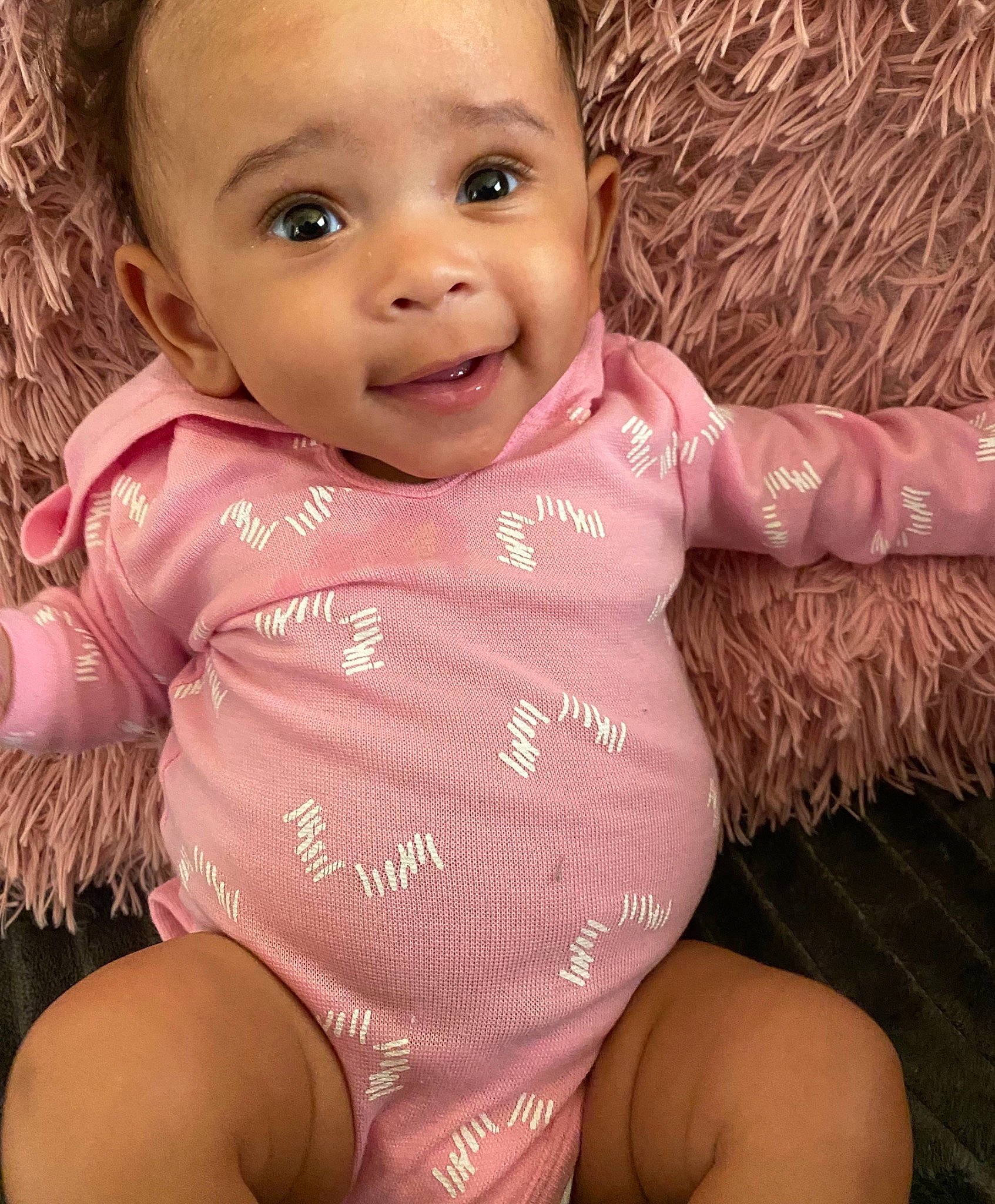 Aaryn joined the competition — help win amazing prizes! baby, baby_toddler_clothing, cheek, eye, eyebrow, finger, gesture, happy, human_body, iris, lip, mouth, neck, nose, organ, person, pink, skin, sleeve, smile