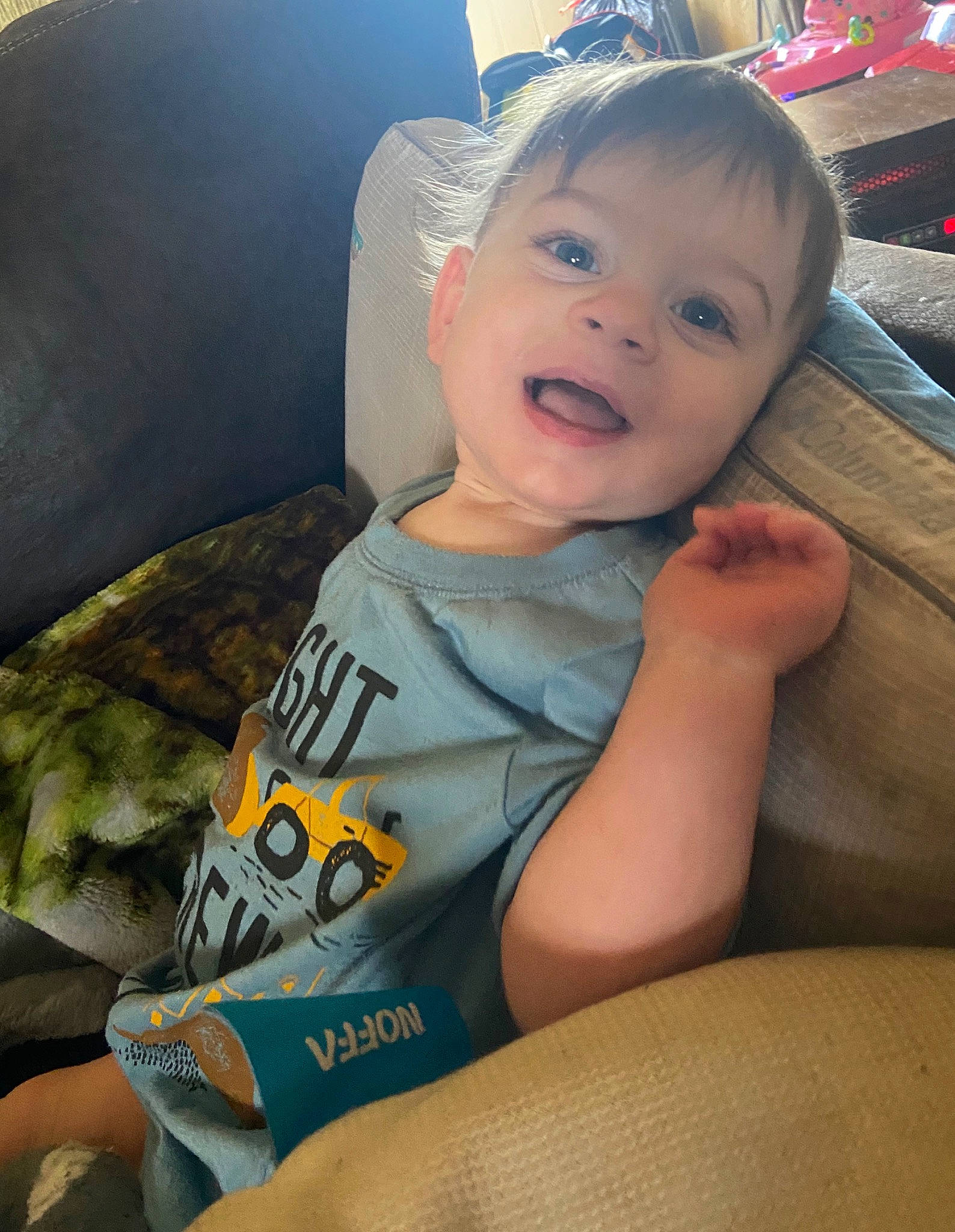 Harlan is registered to the contest to win money with this photo: abdomen, baby, car_seat, cheek, child, cool, eye, face, finger, head, lip, mouth, neck, person, sitting, skin, smile, toddler, world