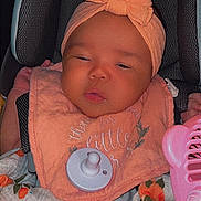 Emarynn joined the competition — help win amazing prizes! baby, infant, car_seat, headband, pacifier, blanket, floral_pattern, clothing, pink, orange, face, person, child, cute, sleepy, indoors, seat, accessory, comfort, toddler