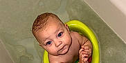 Elijah is registered to the contest to win money with this photo: baby, bathing, bathroom, bathtub, face, head, indoors, person, photography, portrait, room, tub